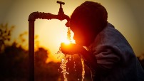 Child drinking water in sunset (Photo illustration for education only)