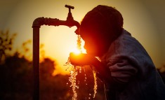 Child drinking water in sunset (Photo illustration for education only)